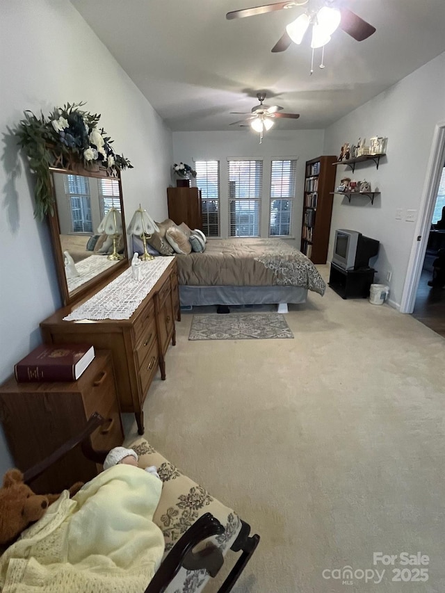 bedroom with light carpet and ceiling fan