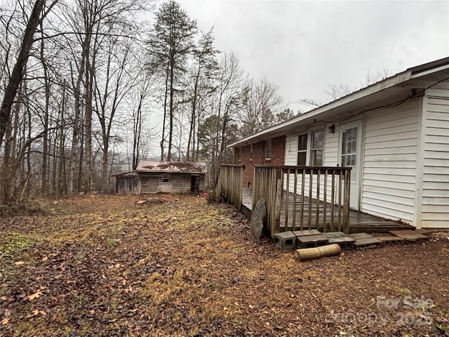 view of yard with a shed and a deck