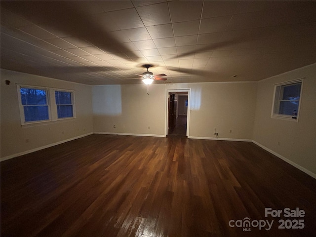 empty room featuring dark hardwood / wood-style floors and ceiling fan