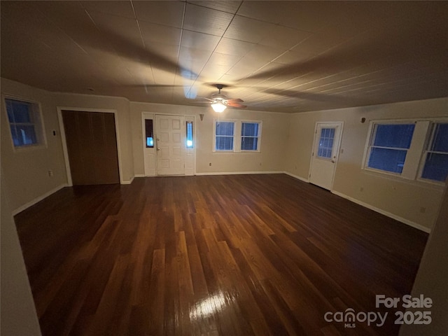 empty room featuring ceiling fan and dark hardwood / wood-style flooring