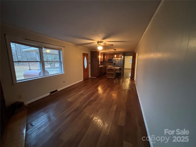 unfurnished living room with dark hardwood / wood-style floors and ceiling fan