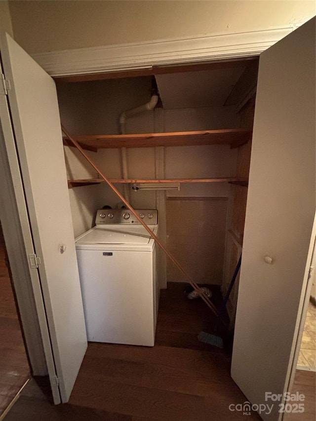 clothes washing area featuring washer / dryer and dark wood-type flooring