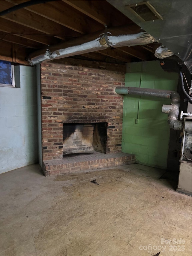 basement with a brick fireplace