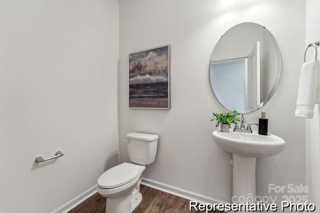 bathroom featuring hardwood / wood-style floors and toilet