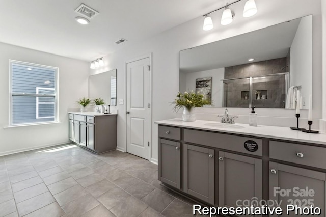 bathroom featuring vanity and a shower with shower door