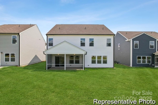 back of property with a lawn and a sunroom