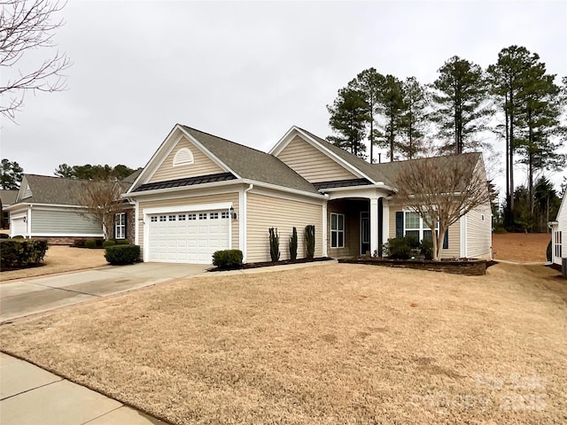 view of front facade with a garage and a front lawn