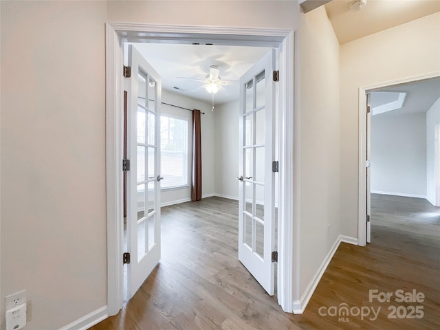 corridor with french doors and light hardwood / wood-style floors