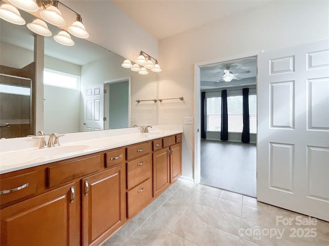 bathroom featuring ceiling fan, tile patterned floors, vanity, and an enclosed shower