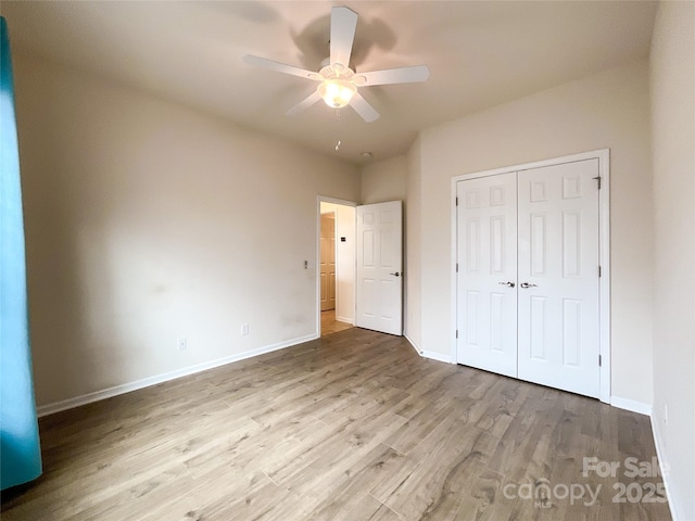 unfurnished bedroom with light hardwood / wood-style flooring, a closet, and ceiling fan