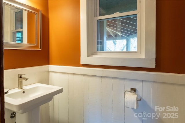 bathroom featuring wainscoting and a sink