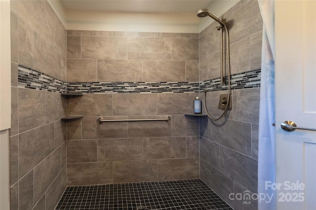 bathroom with a tile shower