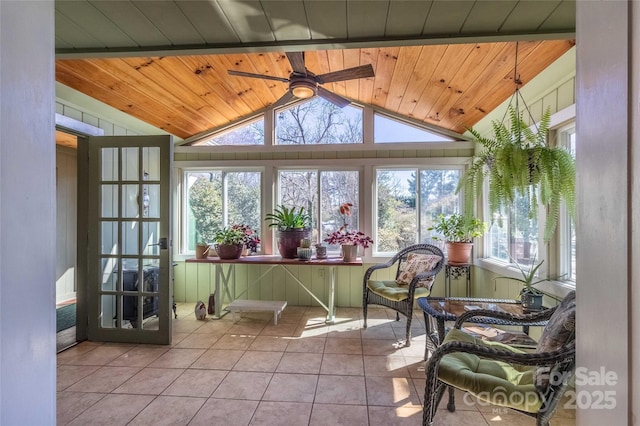 sunroom featuring vaulted ceiling, ceiling fan, wooden ceiling, and a wealth of natural light