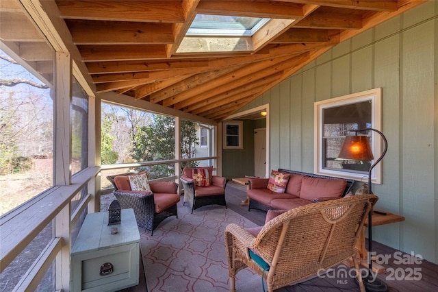 sunroom / solarium featuring vaulted ceiling with skylight