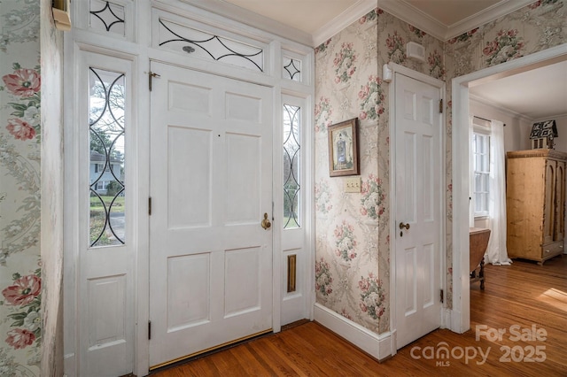 foyer entrance featuring ornamental molding and hardwood / wood-style flooring