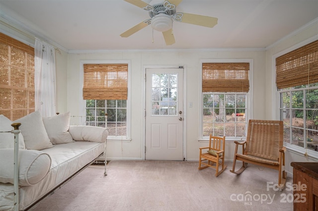 sunroom / solarium featuring ceiling fan