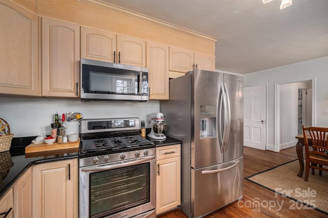 kitchen with ornamental molding, appliances with stainless steel finishes, light brown cabinets, and dark hardwood / wood-style floors