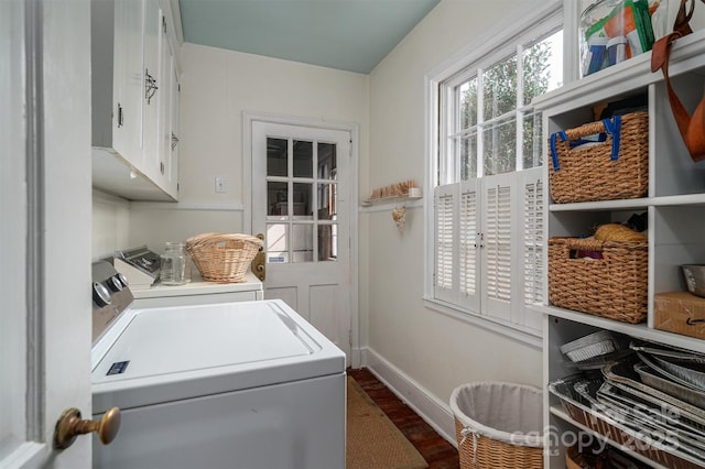 laundry area featuring hardwood / wood-style floors, cabinets, plenty of natural light, and separate washer and dryer