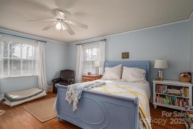 bedroom featuring crown molding, dark hardwood / wood-style flooring, and ceiling fan