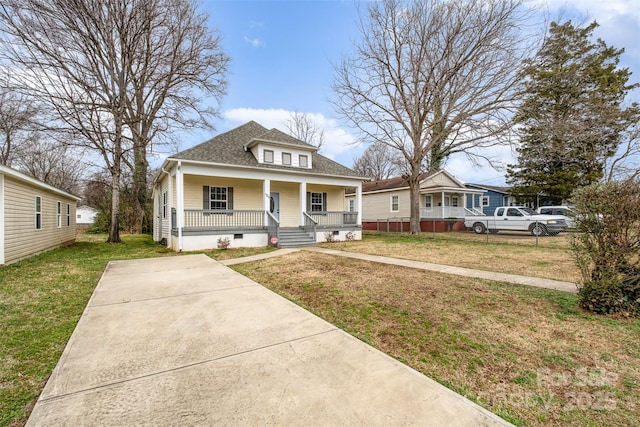 bungalow featuring covered porch and a front yard