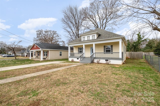 bungalow-style home featuring a front yard and covered porch