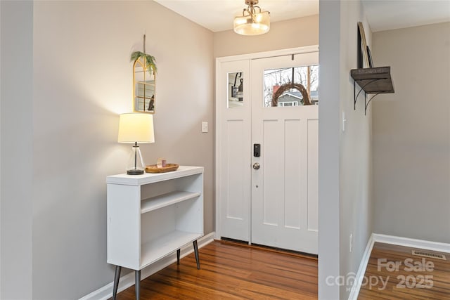 entryway with visible vents, baseboards, and wood finished floors