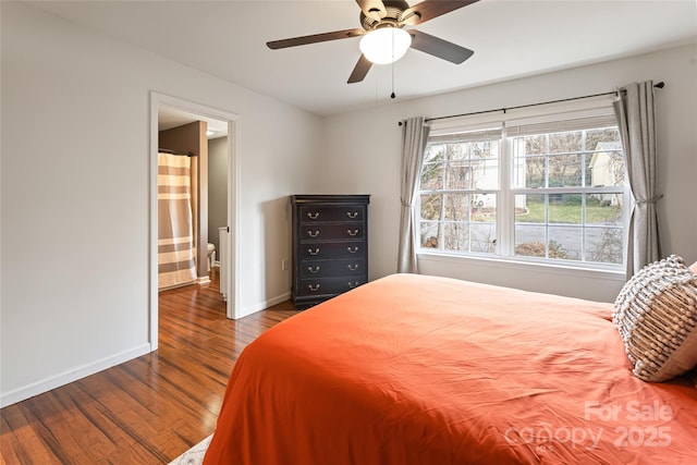 bedroom with ceiling fan, ensuite bath, baseboards, and wood finished floors