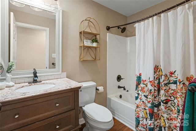 bathroom with toilet, shower / bath combo, and vanity