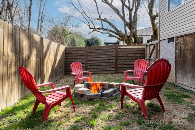 view of yard featuring an outdoor fire pit and a fenced backyard