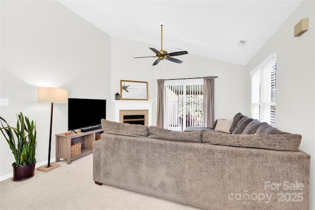 living room featuring ceiling fan, carpet flooring, and vaulted ceiling