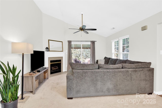 living room with lofted ceiling, light colored carpet, and ceiling fan