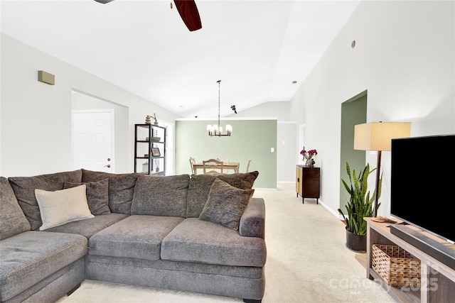 living room featuring lofted ceiling, ceiling fan with notable chandelier, and light carpet