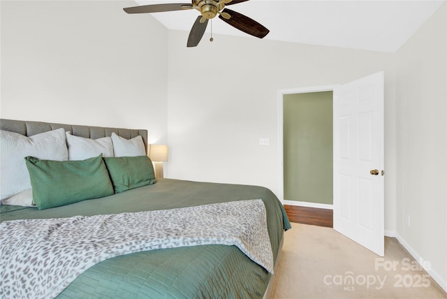 carpeted bedroom with vaulted ceiling and ceiling fan