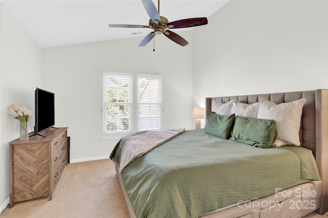 carpeted bedroom with ceiling fan and vaulted ceiling