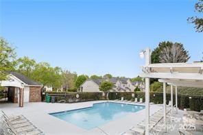 view of swimming pool with a pergola and a patio area