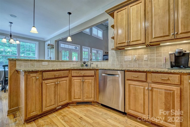 kitchen featuring backsplash, light stone counters, pendant lighting, dishwasher, and kitchen peninsula