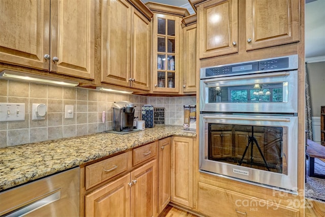 kitchen with stainless steel double oven, light stone counters, and decorative backsplash