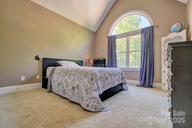 carpeted bedroom with lofted ceiling