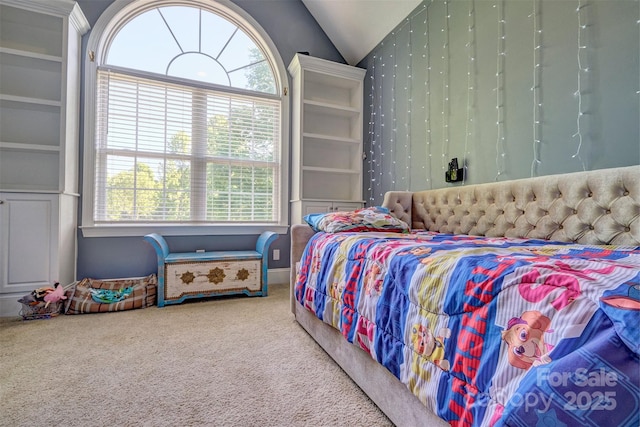 carpeted bedroom featuring vaulted ceiling and multiple windows