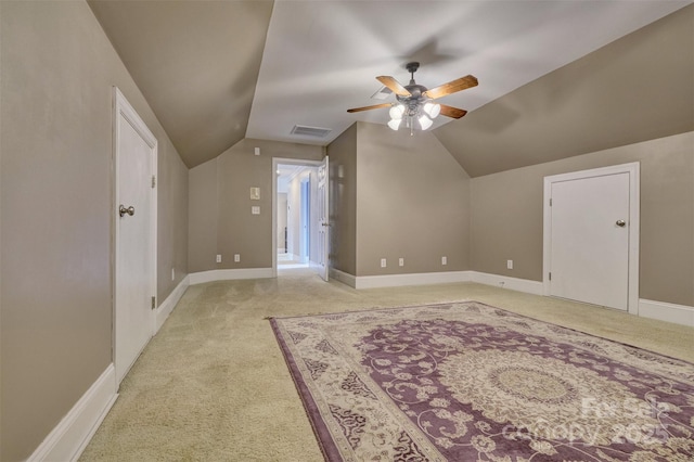 additional living space with vaulted ceiling, ceiling fan, and light colored carpet