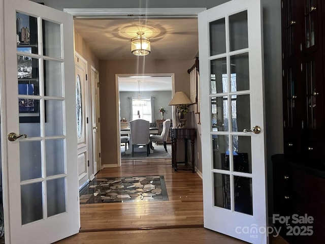 interior space with hardwood / wood-style floors and french doors