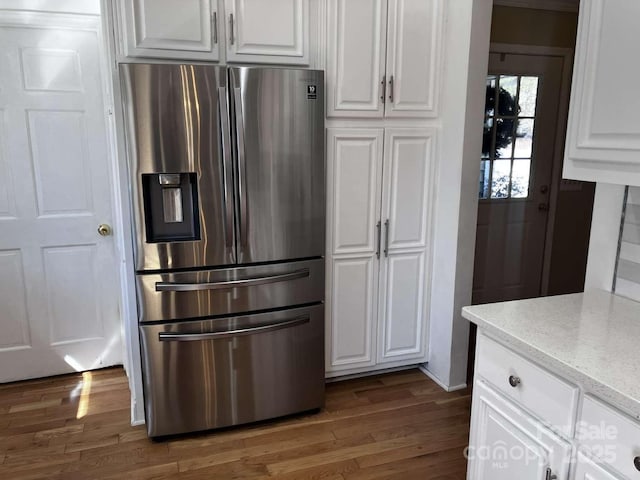 kitchen featuring white cabinetry, dark wood-type flooring, and stainless steel fridge