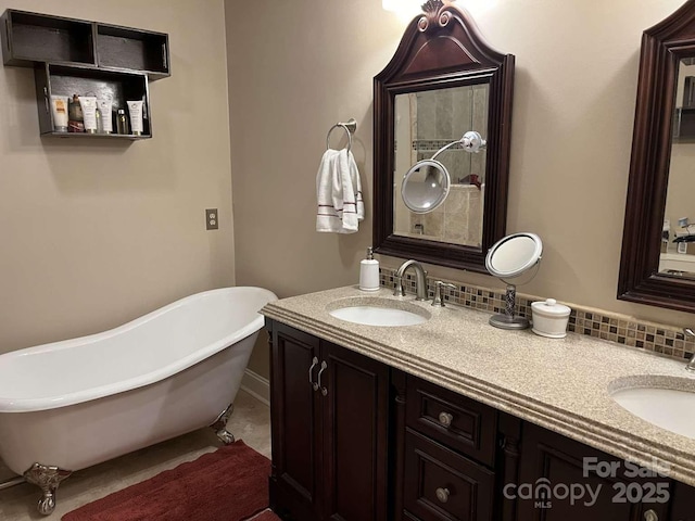 bathroom with vanity, a washtub, and backsplash