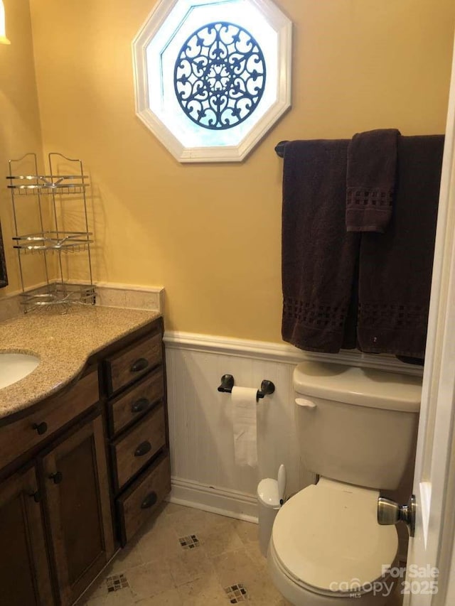 bathroom featuring tile patterned floors, vanity, and toilet