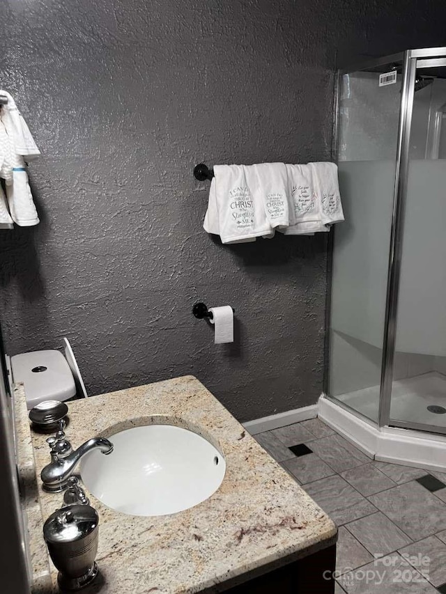 bathroom with vanity, tile patterned floors, and a shower with door