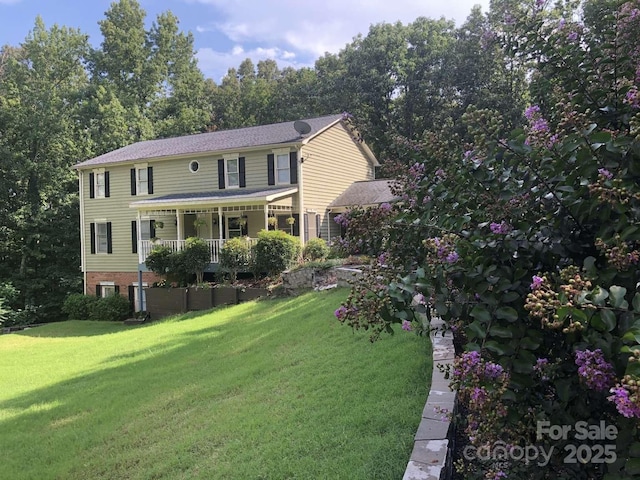 view of front of home featuring covered porch and a front lawn