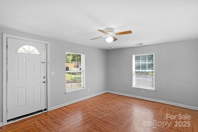 foyer entrance featuring parquet flooring and ceiling fan