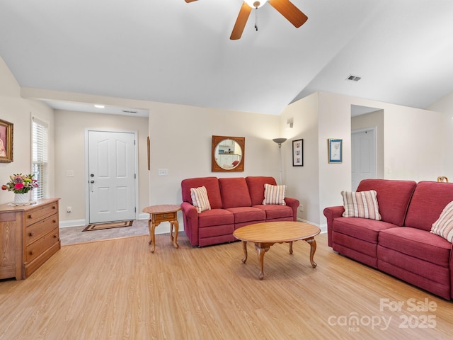 living room featuring vaulted ceiling, light hardwood / wood-style floors, and ceiling fan