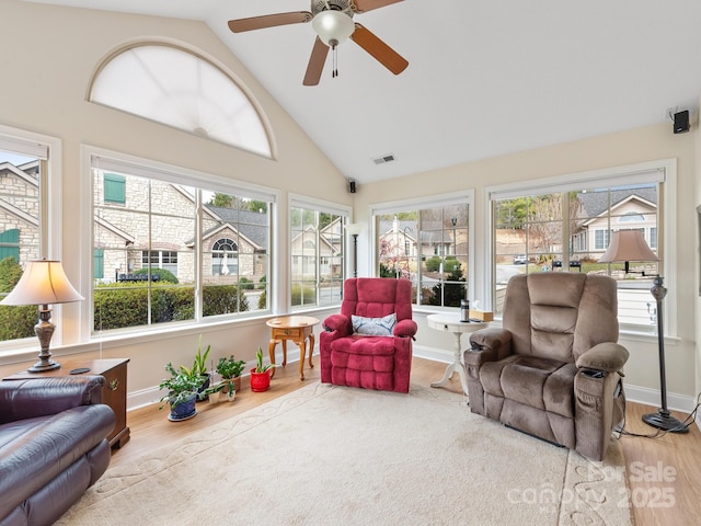 sunroom / solarium featuring lofted ceiling and ceiling fan