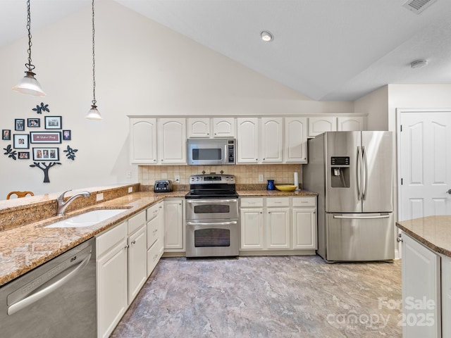 kitchen with stainless steel appliances, sink, pendant lighting, and white cabinets